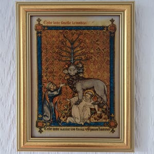 Op de afbeelding: Middeleeuws kunstwerk in een gouden lijst. Het kunstwerk toont een leeuwachtig wezen met meerdere hoofden, figuren in gewaden en Franse tekst. De achtergrond is een patroon van tapijt met blauwe randen.