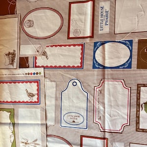 May include: Fabric with various rectangular and oval labels, some with illustrations of a chicken, boots, and wheat. The labels are bordered in red, blue, and green, with the text "Little House Prairie" on some.