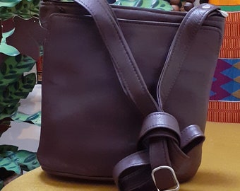 soft leather cross body bag with top zip and two outside pockets in a stunning, elegant rich brown. 17x17cm