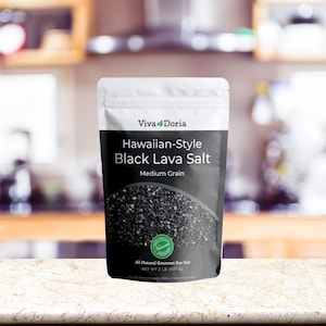 May include: A white resealable pouch of black lava salt, labeled "Viva Doria Hawaiian-Style Black Lava Salt Medium Grain". The pouch contains 2 pounds (907 grams) of all-natural gourmet sea salt.