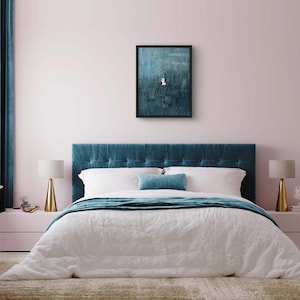 May include: A rectangular wall art piece featuring a dark teal textured abstract painting in a black frame. The artwork displays a small white geometric shape centered against a deep, layered teal background with visible brushstroke textures.