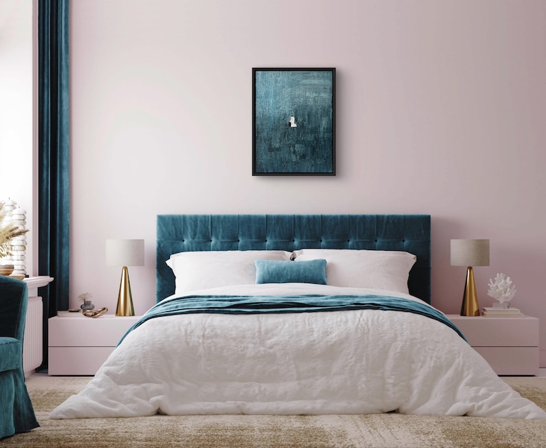 May include: A rectangular wall art piece featuring a dark teal textured abstract painting in a black frame. The artwork displays a small white geometric shape centered against a deep, layered teal background with visible brushstroke textures.