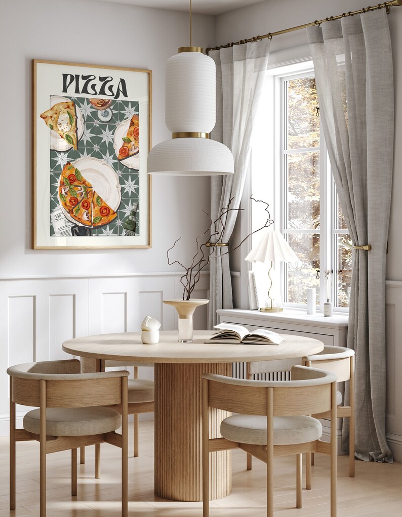 May include: A round wooden dining table with four chairs. The table has a fluted base and the chairs have light brown upholstery. A framed poster with the word "Pizza" and a depiction of pizza slices is hanging on the wall behind the table.