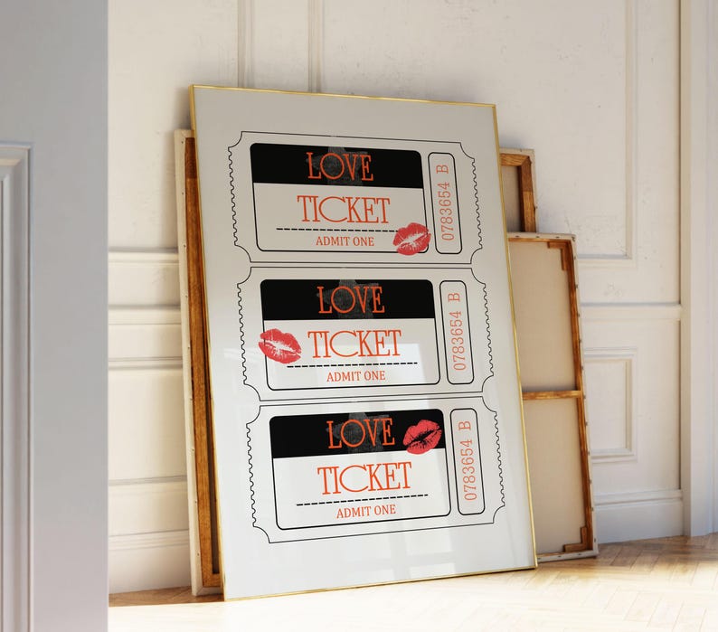 May include: Three white tickets with black borders and red lips printed on them. Each ticket says "LOVE TICKET" and "ADMIT ONE". The tickets are framed in a gold frame.