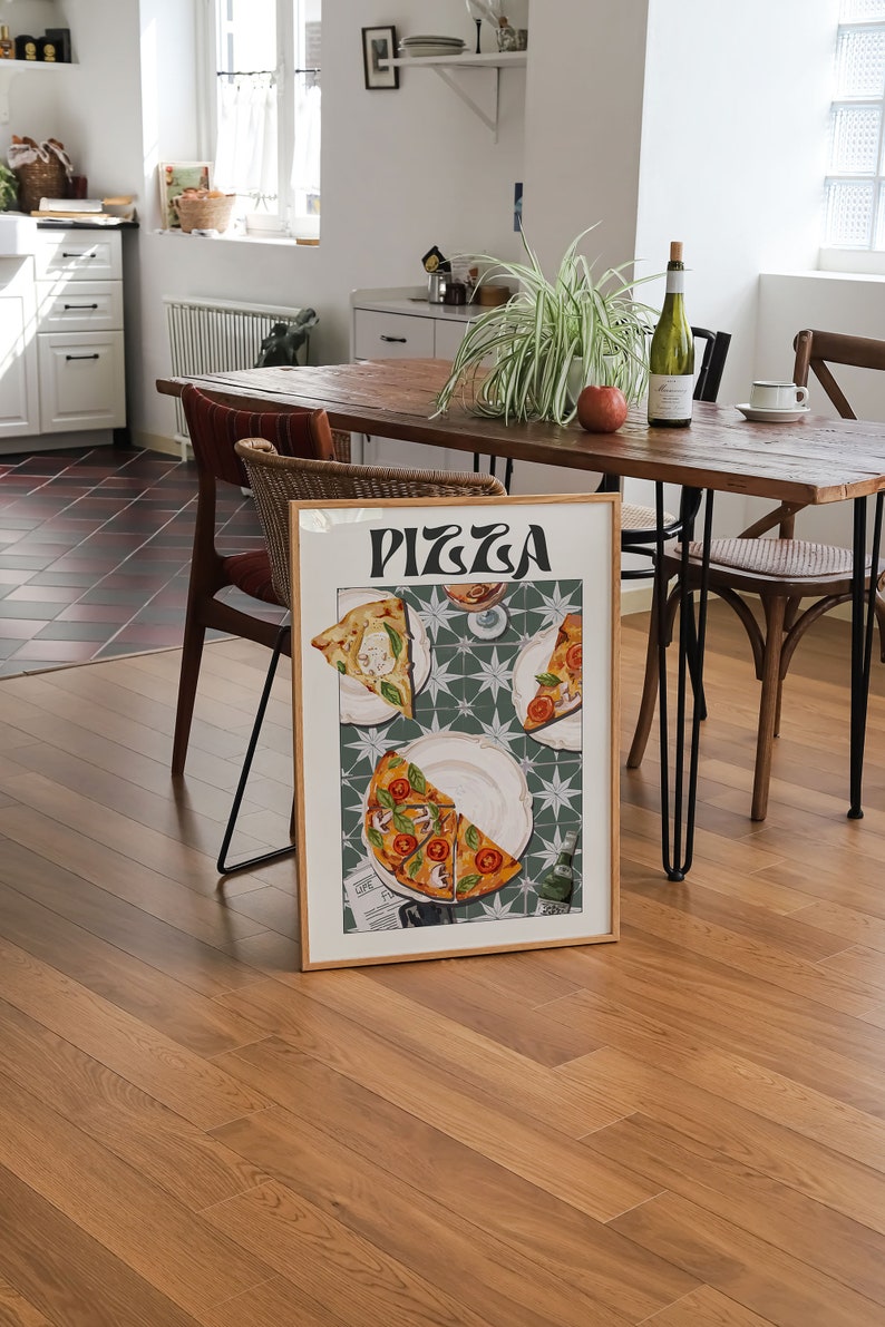 May include: A framed print of a pizza illustration with the word "PIZZA" in a retro font. The pizza slices are on white plates with a green and white tiled background.