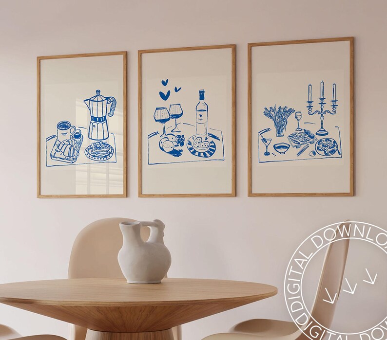May include: Three framed prints with blue illustrations of breakfast, wine, and a candlelit dinner. Each print features a white background and a wooden frame.