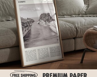 May include: A framed black and white print featuring a coastal landscape with the word "CORFU" at the top. The print includes text describing the location and is displayed on a wooden floor.