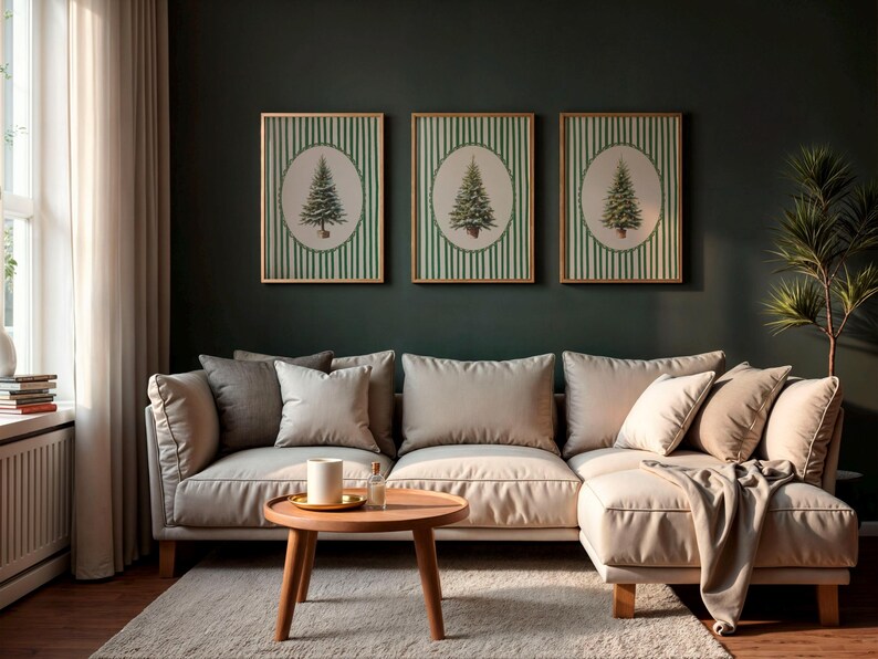 May include: Three framed wall art pieces featuring a green Christmas tree design on a striped background. The art hangs above a beige sectional sofa with pillows. A round wooden coffee table and a rug complete the living room setting.