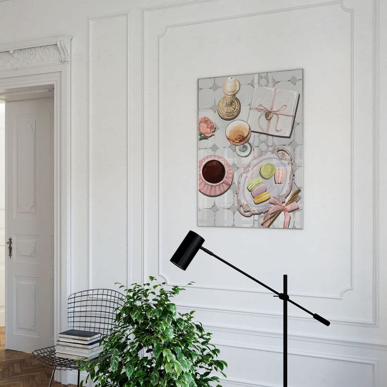 May include: A painting of a still life with a pink and white teacup, a glass of wine, a wrapped gift, a candle, and macarons on a plate. The background is a light gray with a pattern of squares.