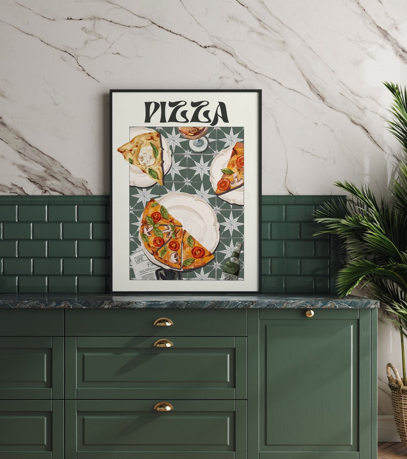 May include: A framed print with the word "PIZZA" in a retro font. The print features a still life of three slices of pizza on a white plate with a green and white tiled background.