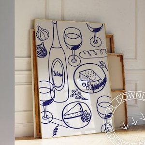May include: A white framed print with a blue illustration of a bottle of wine, glasses of wine, cheese, bread, and grapes. The illustration is in a doodle style.