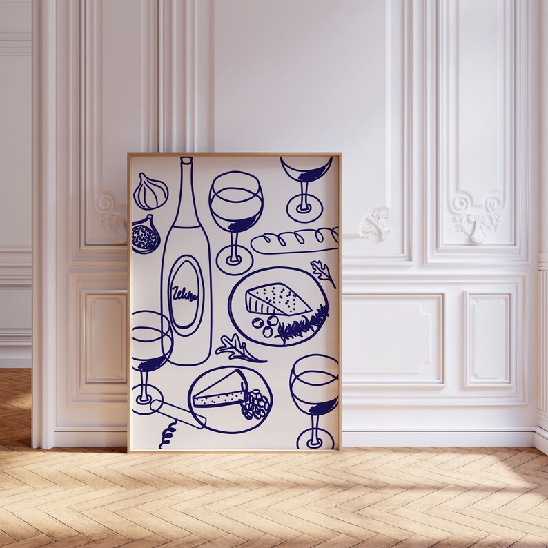 May include: A white poster with a blue illustration of a bottle of wine, glasses, cheese, bread, and grapes. The poster is framed in a light wood frame.