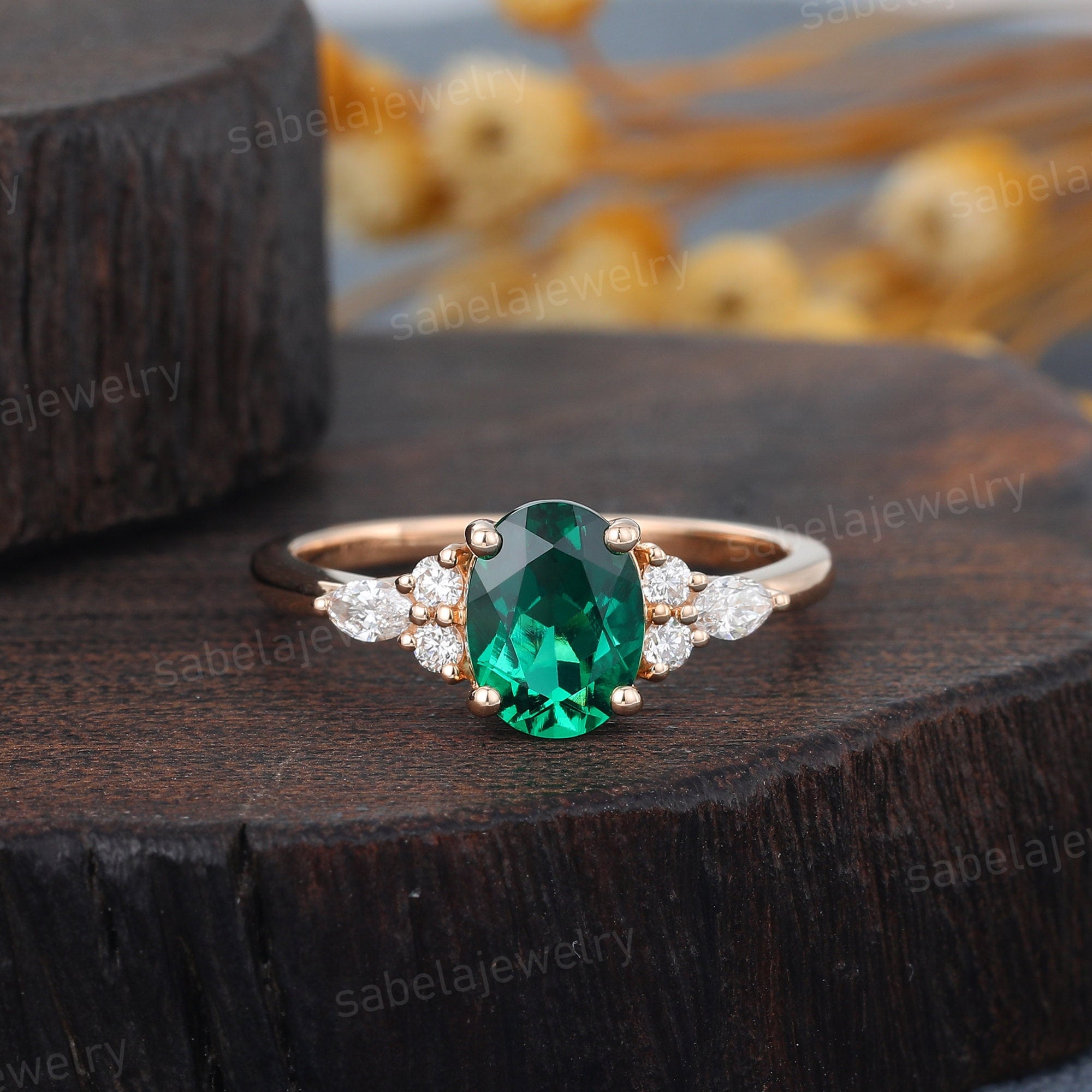 Amazing oval shaped emerald ring surrounded by cluster of diamonds.