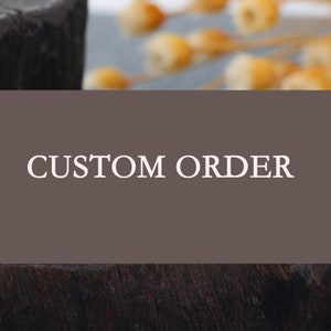 May include: A brown wooden sign with the text "CUSTOM ORDER" in white lettering.