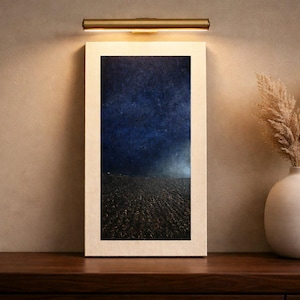 Original artist-signed oil painting of dark sky over fields, with picture light