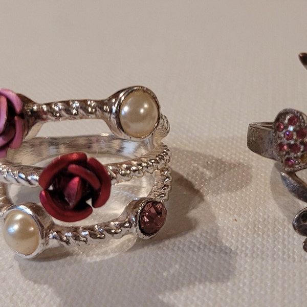 Four dressy cocktail rings and costume rings