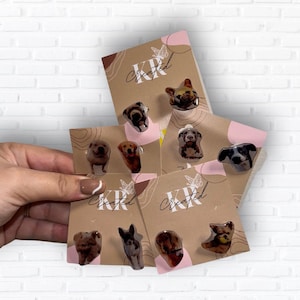 May include: A selection of dog breed stud earrings presented on kraft paper cards. The earrings showcase different dog breeds with a glossy finish. The cards are branded with "KR Created" and feature butterfly and abstract designs.