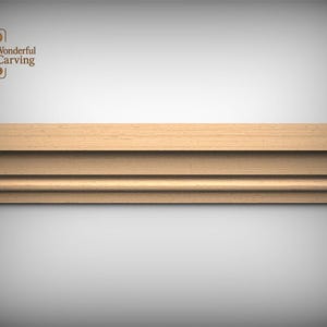 May include: A light-colored wooden molding strip featuring a linear design with multiple horizontal grooves and a rounded edge. The top left corner displays a logo with a decorative leaf icon and the text Wonderful Carving.