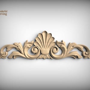 May include: A light-colored wooden carving featuring a central shell motif flanked by symmetrical scrolling acanthus leaf patterns. The piece displays a smooth, natural wood grain texture and includes the text Wonderful Carving in the corner.