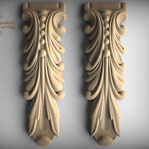 May include: Two wooden decorative corbels with a carved leaf and scroll design. The corbels are light brown and feature a central row of beads. The top has a rectangular shape with a small hole.