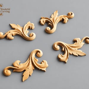 May include: Four light-colored wooden carvings featuring intricate acanthus leaf scrollwork designs. Each piece displays curved, organic shapes with detailed textures. The top left corner includes a logo with the text Wonderful Carving.