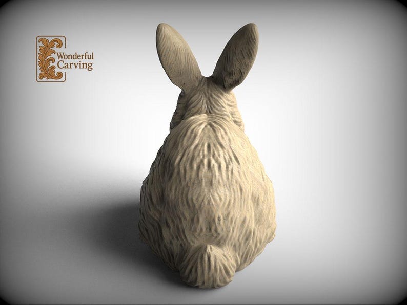 A wooden rabbit statue with large ears, sitting on a plain background.