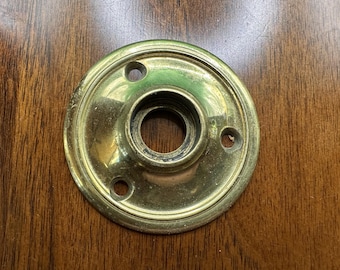 Cast brass rosette escutcheons, about 2 1/4" diameter, with screws. Marked Essex