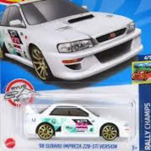 May include: White '98 Subaru Impreza 22B-STi Version die-cast toy car with gold wheels. The car is part of the Hot Wheels Rally Champs series. The packaging features the Hot Wheels logo and car details.