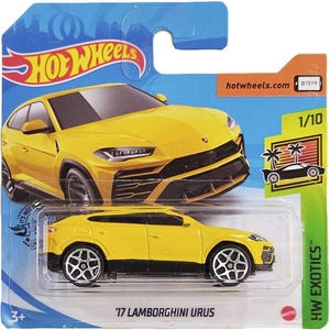May include: A yellow '17 Lamborghini Urus die-cast model car on a blue and green Hot Wheels card. The car has black accents and silver wheels. The card features the Hot Wheels logo and the text "HW Exotics".