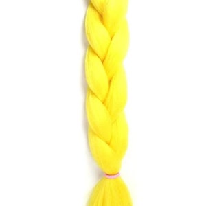 May include: A single braid of bright yellow synthetic hair, pre-braided and ready to be added to a hairstyle. The braid is tied off with a pink elastic band.