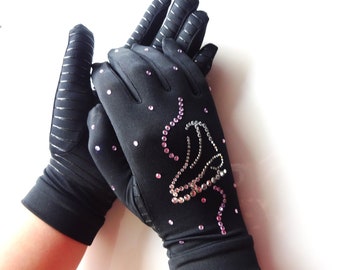May include: A pair of black fingerless gloves with a sparkly silver and pink ice skate design on one glove.