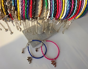 May include: A collection of braided leather bracelets in various colors, with silver-tone chain accents and charms. Two bracelets, one blue and one pink, are displayed at the bottom, each with a roller skate charm and star charm.