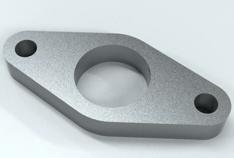 May include: A silver metal spacer with a large center hole and two smaller holes on the sides. The spacer is designed to fit between two pipes or other components.