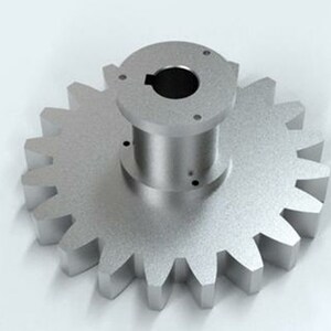 May include: A silver metal gear with a central hub and a series of teeth around the outer edge. The gear is designed to mesh with other gears to transmit power.