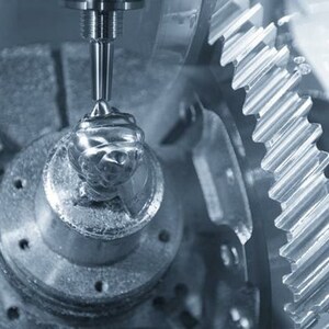 May include: Close-up of a metal gear being machined by a CNC milling machine. The gear is being cut by a rotating tool, leaving a shiny, metallic finish.