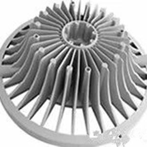 May include: A silver metal heat sink with a circular base and a series of radiating fins. The fins are arranged in a radial pattern and are designed to dissipate heat.
