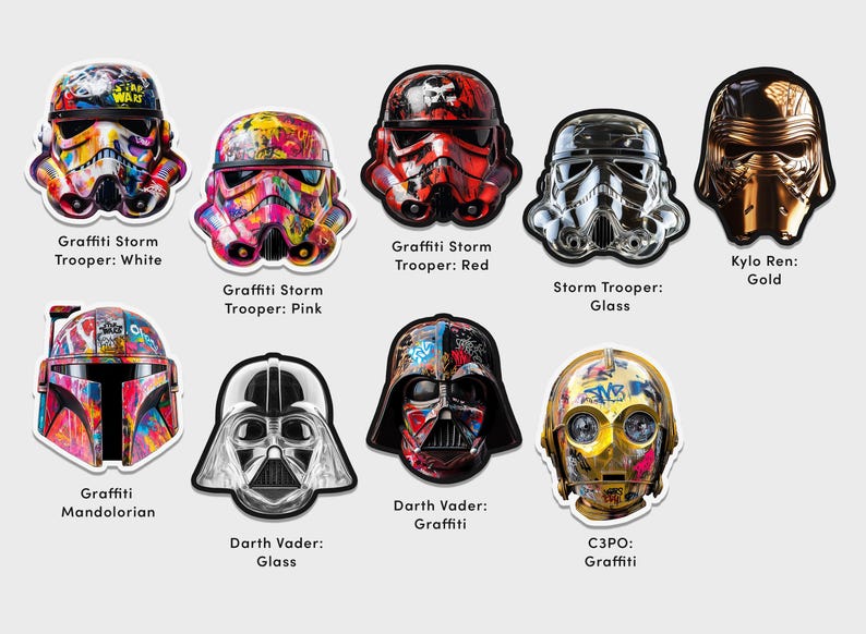 May include: A collection of Star Wars character helmets decorated with colorful graffiti art. The helmets include Stormtroopers, Darth Vader, Kylo Ren, and C3PO. The helmets are displayed on a white background.