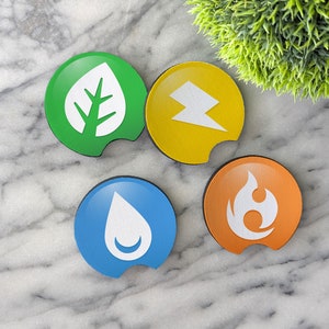 May include: Four round coasters with different colored backgrounds and white symbols. The coasters are green, yellow, blue, and orange. The symbols are a leaf, a lightning bolt, a water drop, and a flame.