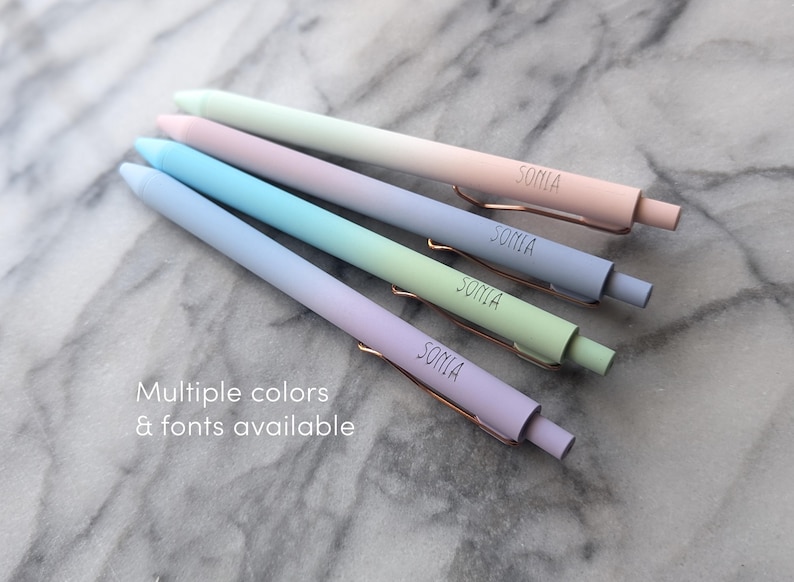 May include: Four ombre pens with the name "Sonia" printed on each. The pens are in shades of pink, blue, green, and purple.