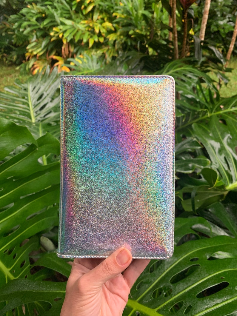 May include: A silver iridescent notebook cover with a subtle sparkle finish.