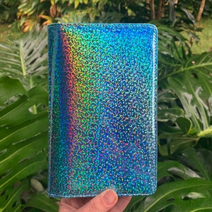 May include: A blue iridescent glitter wallet with a holographic finish.