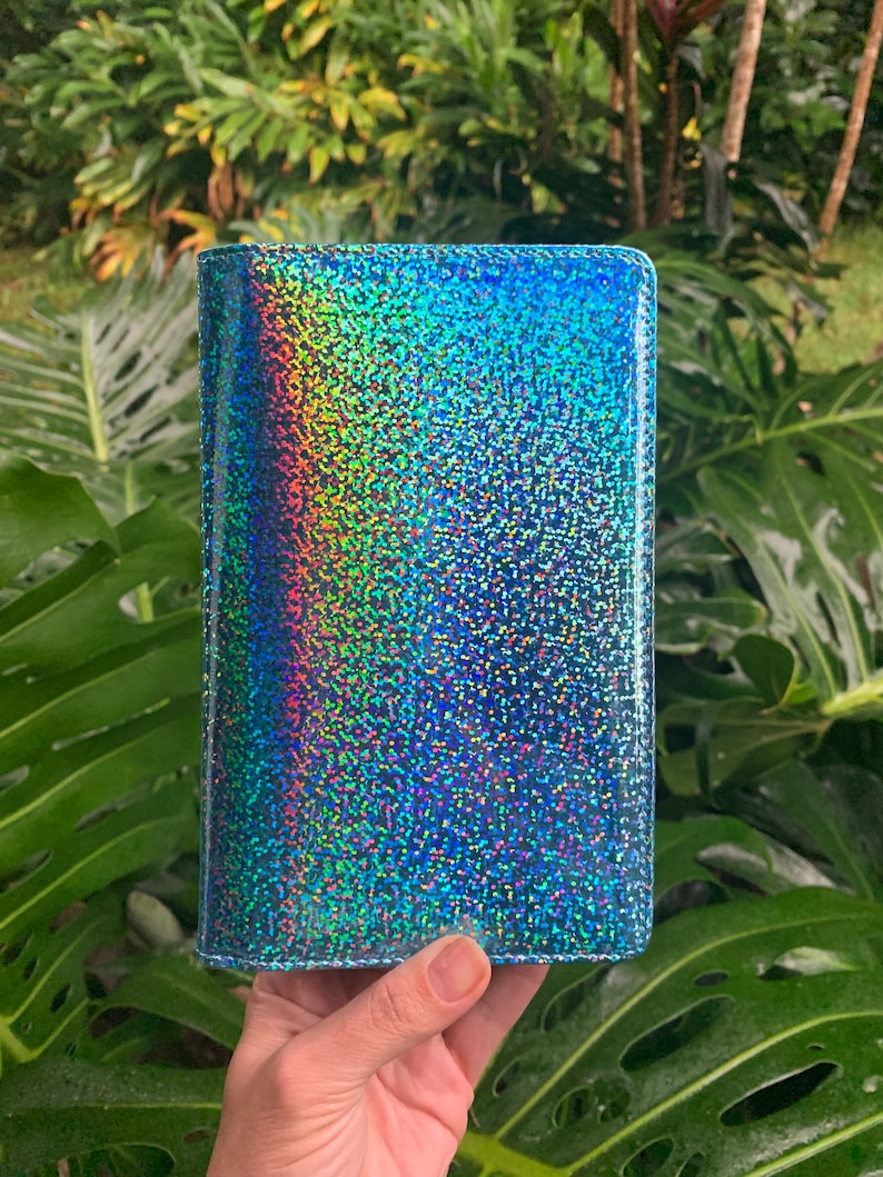 May include: A blue iridescent glitter wallet with a holographic finish.