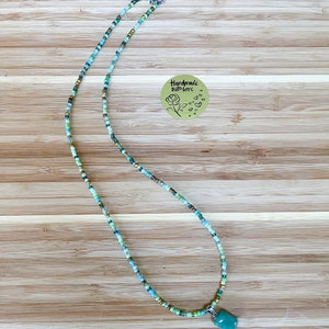 Green, blue and gold seed bead necklace with healing stone pendant