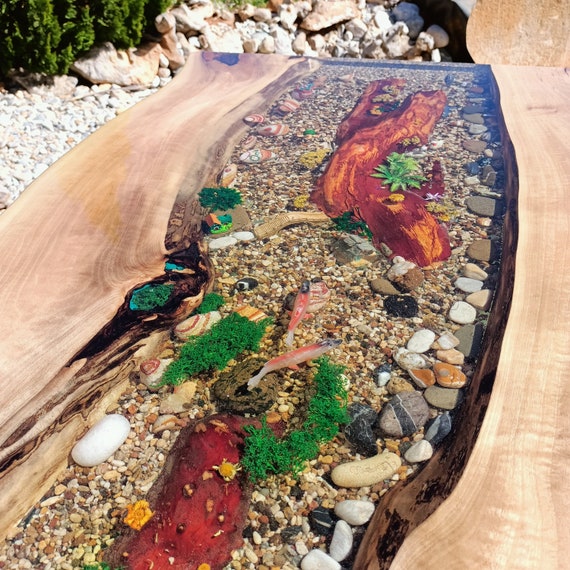 A custom live-edge walnut slab split by an ocean-blue epoxy river — furniture that functions as a sculptural centerpiece, with 22 favorites backing the demand.