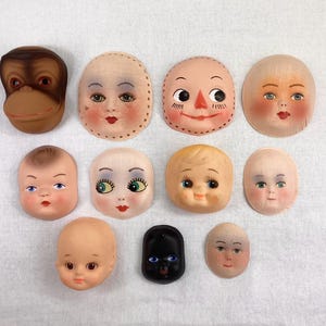 May include: Assortment of 10 doll face blanks, including a monkey face, a black face, and 8 different human faces. The faces are made of paper mache and are ready to be painted.