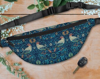 May include: A blue fanny pack with a floral pattern and birds. The pack has a black adjustable strap.