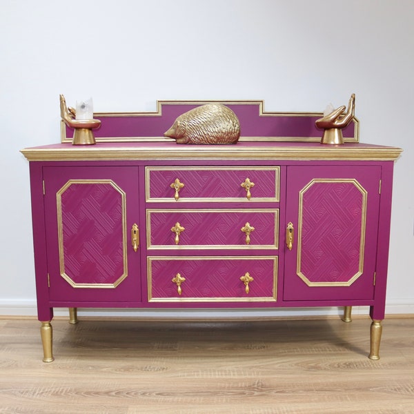 SOLD SOLD. Please note this item is sold. Beautiful fuchsia sideboard / Buffett with gold detail and textured doors and drawers.