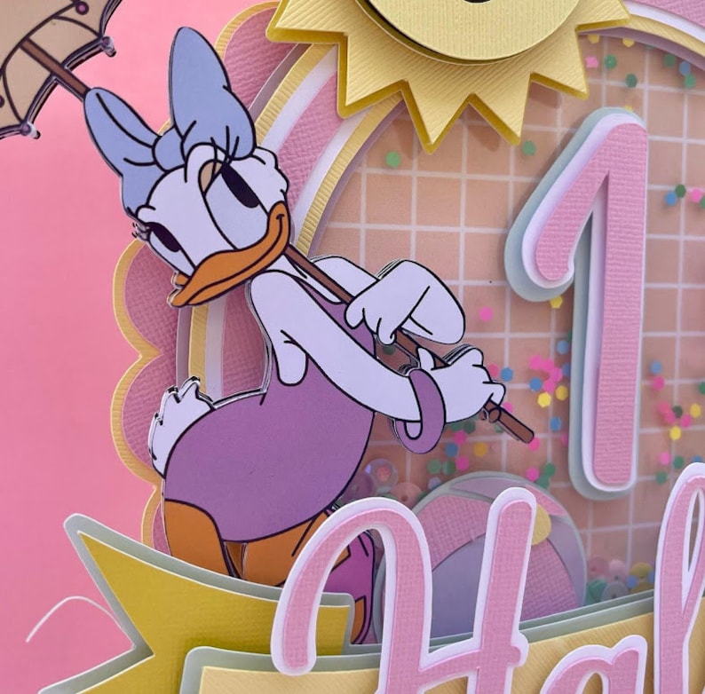 K&ouml;nnte beinhalten: Eine mehrschichtige Papierarbeit in Rosa und Gelb mit einer Comic-Ente, die einen lila Badeanzug tr&auml;gt und einen Regenschirm h&auml;lt. Die Ente steht vor einer pinkfarbenen Zahl Eins mit einer gelben Sonne und einem Gittermuster im Hintergrund. Der Text "Happy" ist am unteren Rand des Bildes sichtbar.