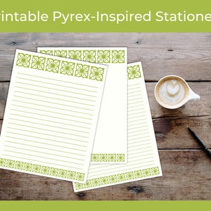 May include: Printable stationery with a Pyrex-inspired design. The stationery features a green floral border and lined pages. A cup of coffee and a pen are also on the wooden surface. The text "Printable Pyrex-Inspired Stationery" is at the top.