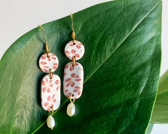 Handmade earrings made of polymer paste and gold-plated golden nails